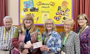 Gillian the Minister of the Messy Church receiving the TRCS cheque from President Jyl. 